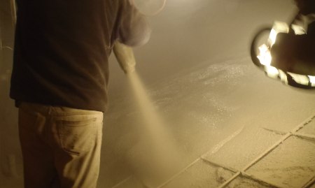 A basement being waterproofed with a membrane applied to the walls.
